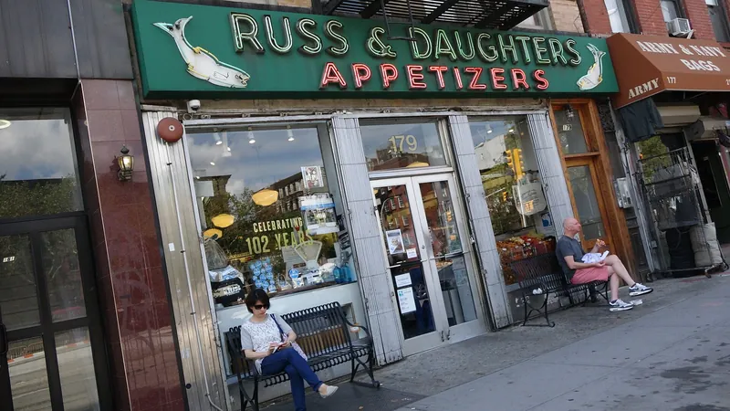 Russ & Daughters Appetizers storefront with its green neon sign